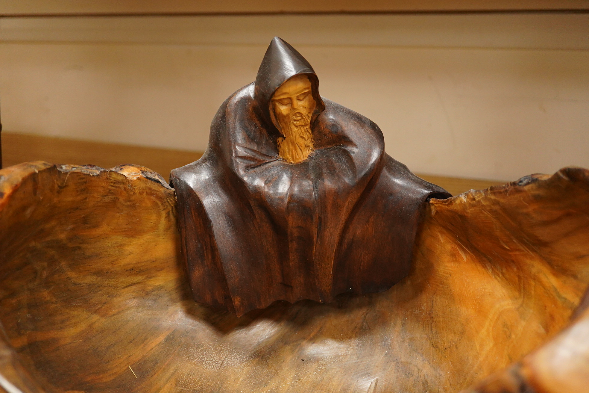 Pierre Decorse (b.1953), a large naturalistically modelled bowl carved with a cloaked figure, 42cm wide